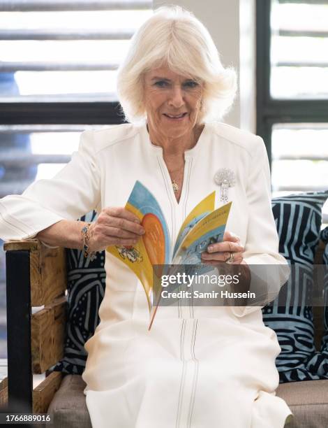 Queen Camilla reads Lion and Mouse with children during her visit to Eastlands Library, with King Charles III, where she met the founders of Book...