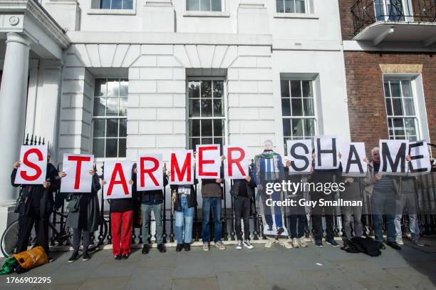 Demonstrators hold banners reading 'Starmer Shame' following Labour Leader Keir Starmer's speech on the situation in the Middle East on October 31,...