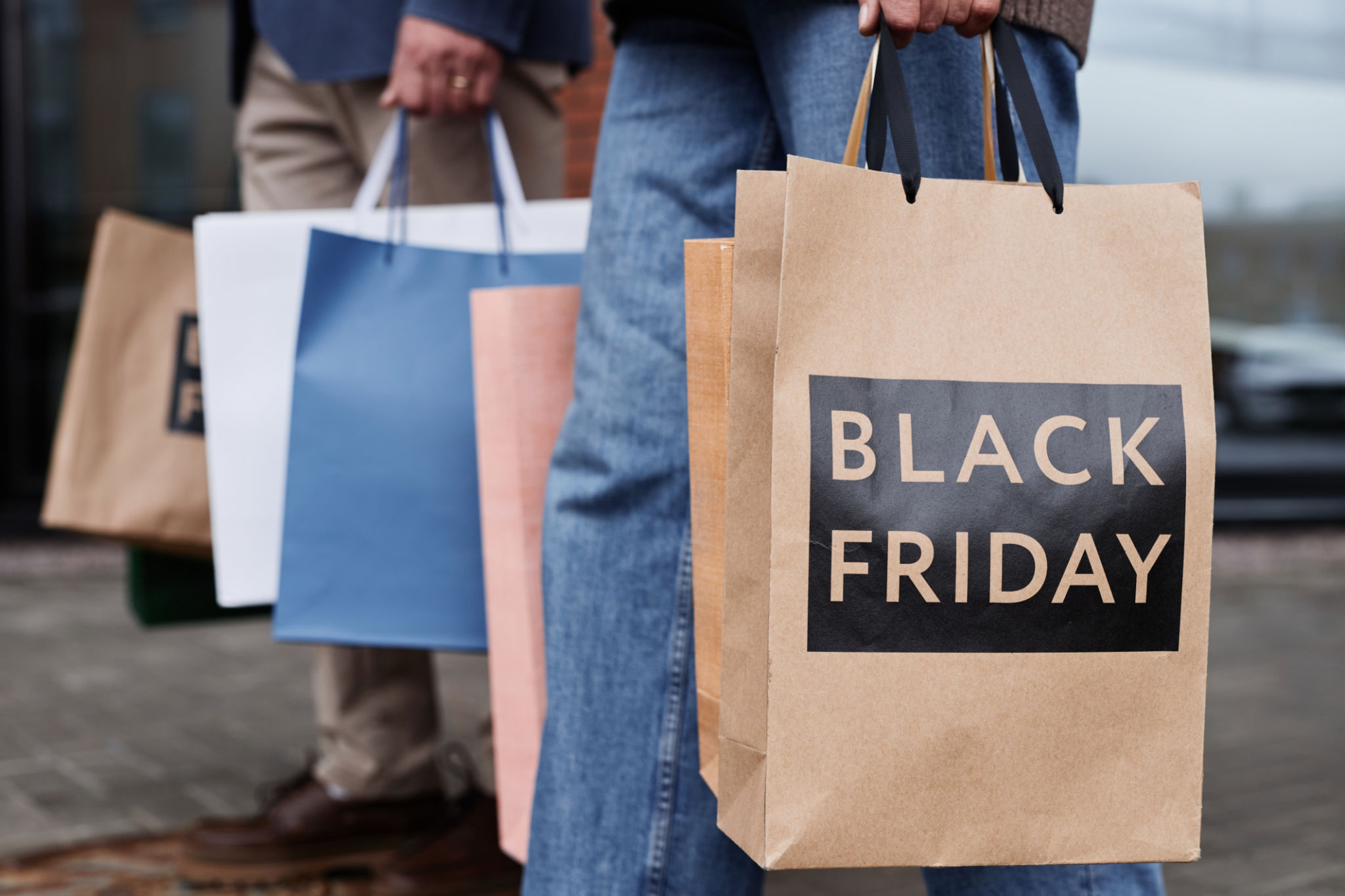Close up of couple holding Black friday shopping bags Close up of couple holding Black friday shopping bags