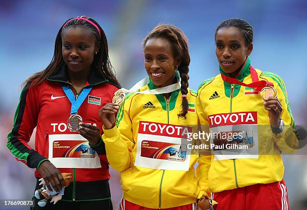 Silver medalist Mercy Cherono of Kenya, gold medalist Meseret Defar of Ethiopia and bronze medalist Almaz Ayana of Ethiopia stand on the podium...