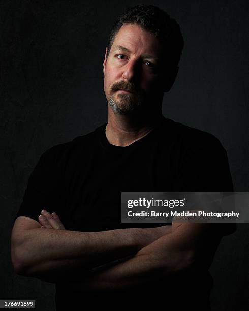 portrait on man in black t-shirt - schwache beleuchtung stock-fotos und bilder