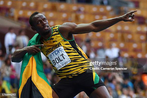 Usain Bolt of Jamaica celebrates winning the gold medal in the Men's 200 metres final during Day Eight of the 14th IAAF World Athletics Championships...