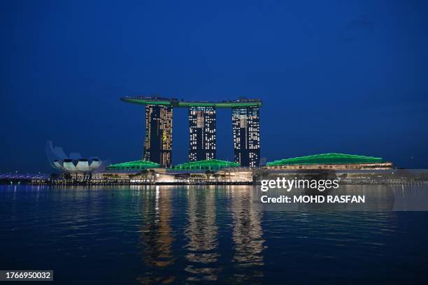 The Marina Bay Sands hotel resort is seen lit up in green to celebrate the Earthshot Prize and United for Wildlife, in Singapore on November 6, 2023....