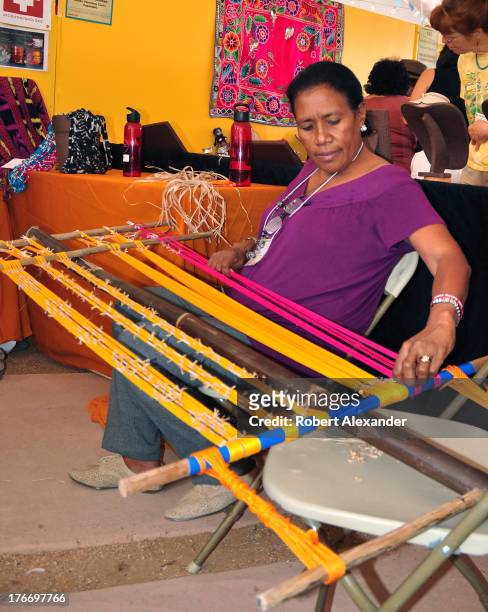 Cipriana Amaral from Timor-Leste demonstrates how she makes her handwoven cotton textiles at the International Folk Art Market in Santa Fe, New...
