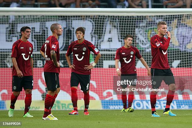 Lars Stindl, Leon Andreasen, Hiroki Sakai, Sebastien Pocognoli and Andre Hoffmann of Hannover look dejected after the third goal of Moenchengladbach...