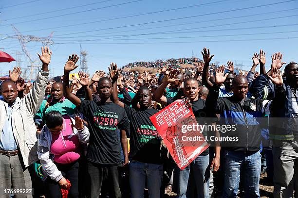 Miners and supporters of the Marikana mining community pray during a memorial service to commiserate the one year anniversary of the massacre at...
