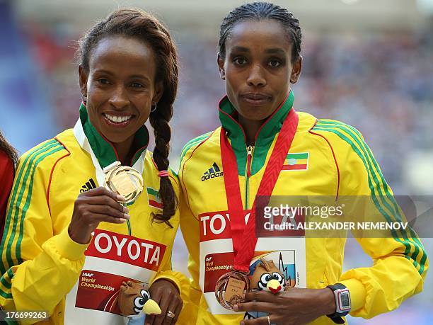 Gold medalist Ethiopia's Meseret Defar and bronze medalist Ethiopia's Almaz Ayana pose on the podium during the medal ceremony for the women's 5000...