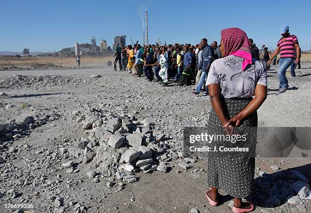 Resident of the Marikana watches as miners and supporters of the Marikana mining community march near the Lonmin Platinum Mine to commiserate the one...