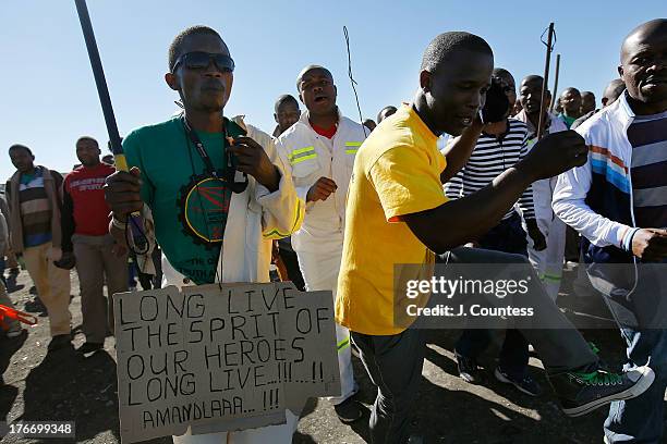 Miners and supporters of the Marikana mining community march near the Lonmin Platinum Mine to commiserate the one year anniversary of the massacre at...