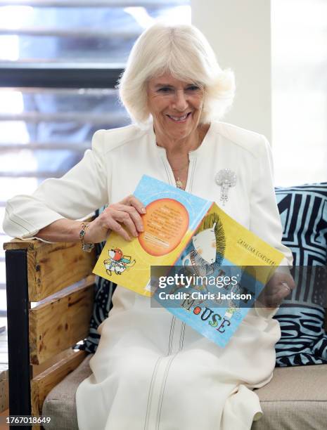 Queen Camilla reads Lion and Mouse during her visit to Eastlands Library, with King Charles III, where she met the founders of Book Bunk, a Kenyan...