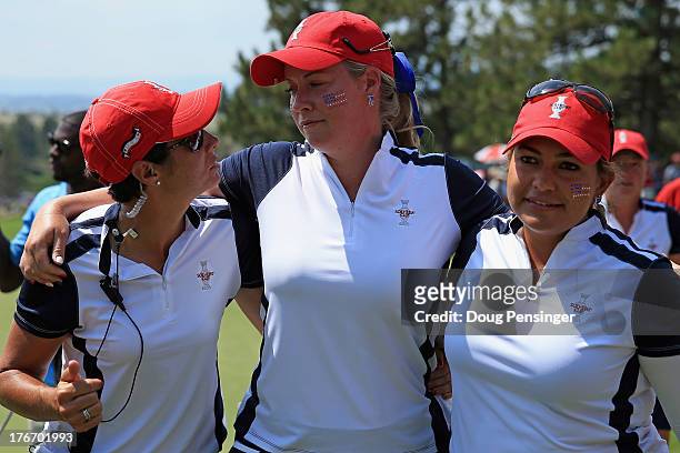 Assistant captain Laura Diaz joins Brittany Linciome and Lizette Salas of the United States Team on the 18th green after they halved their match with...