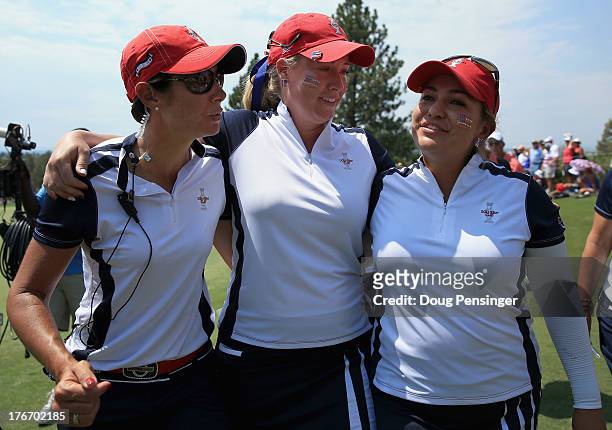 Assistant captain Laura Diaz joins Brittany Linciome and Lizette Salas of the United States Team on the 18th green after they halved their match with...