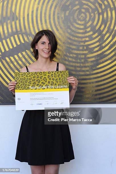 Marina Rosset poses with the Action Light award during the 66th Locarno Film Festival on August 17, 2013 in Locarno, Switzerland.