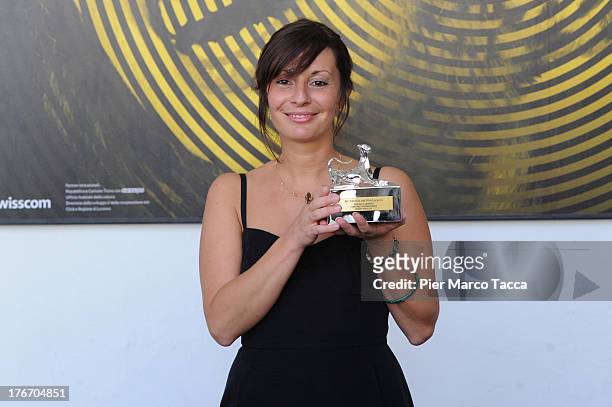 Cristina Picchi poses with thePardino d'argento award during the 66th Locarno Film Festival on August 17, 2013 in Locarno, Switzerland.