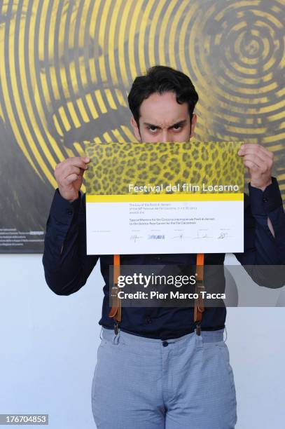 Reza Gamini poses with the menzione special award during the 66th Locarno Film Festival on August 17, 2013 in Locarno, Switzerland.