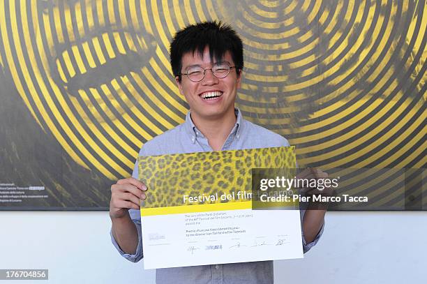 Ivan Tan poses with the Film und Video Untertitelung award during the 66th Locarno Film Festival on August 17, 2013 in Locarno, Switzerland.