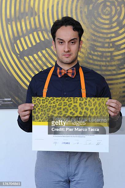 Reza Gamini poses with the menzione special award during the 66th Locarno Film Festival on August 17, 2013 in Locarno, Switzerland.
