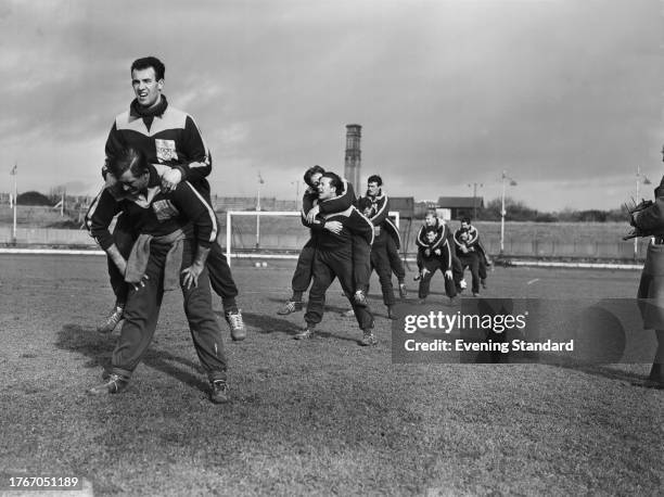 Players of West Ham United Football Club carrying teammates piggyback during a training session in London, February 20th 1958.