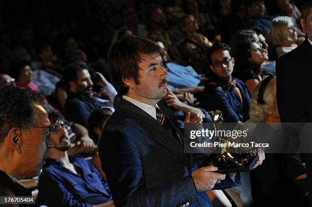 Albert Serra poses with the Pardo d'oro during the 66th Locarno Film Festival on August 17, 2013 in Locarno, Switzerland.