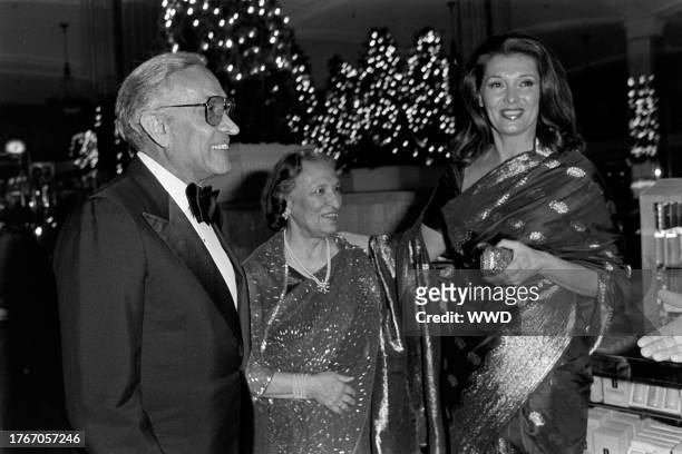 Mehli Mehta, Tehmina Mehta, and Nancy Kovack attend an event at the flagship location of Lord & Taylor on November 28, 1984.