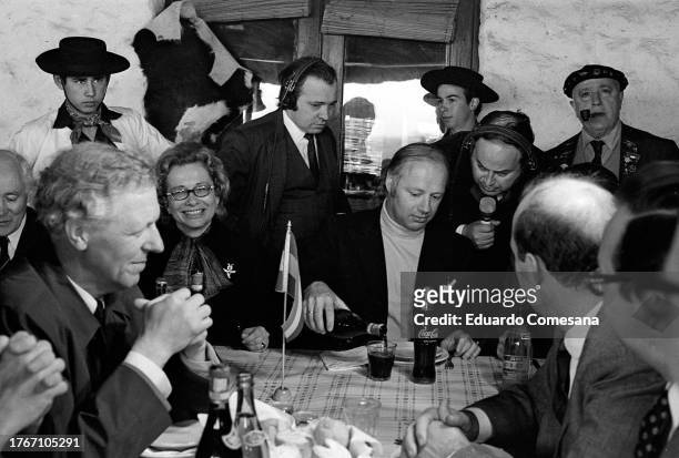 Seated with unidentified others, Dutch musical conductor Bernard Haitink is interviewed at a table in El Mangrullo restaurant, Ezeiza, Argentina,...