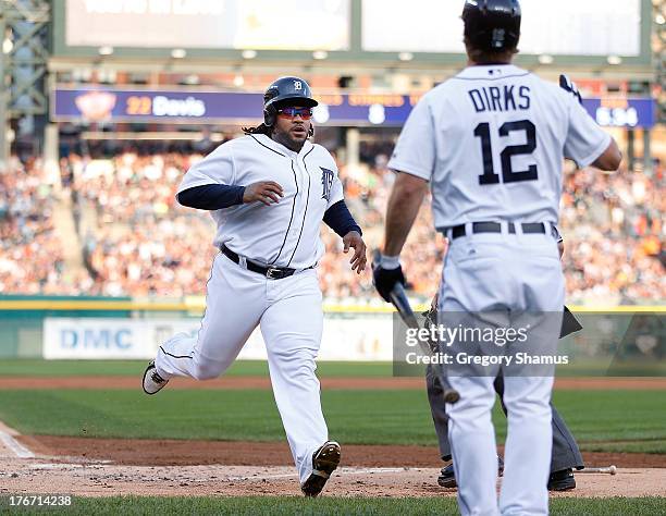 Prince Fielder of the Detroit Tigers scores a first inning run behind Andy Dirks while playing the Kansas City Royals at Comerica Park on August 17,...