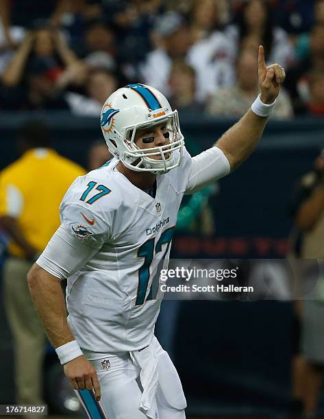 Ryan Tannehill of the Miami Dolphins celebrates a first half touchdown against the Houston Texans during a preseaon game at Reliant Stadium on August...