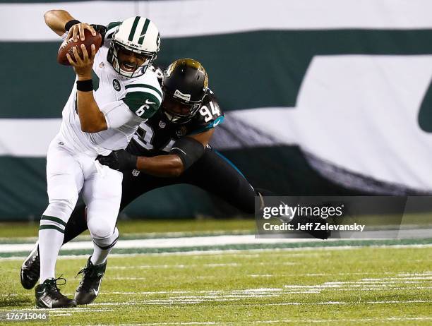 Jeremy Mincey of the Jacksonville Jaguars sacks Mark Sanchez of the New York Jets during their preseason game at MetLife Stadium on August 17, 2013...