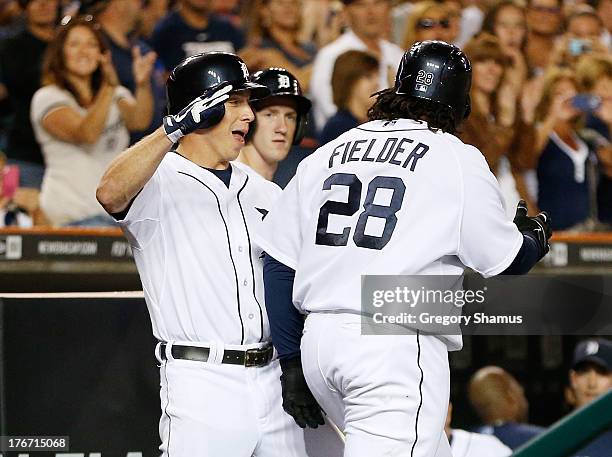 Prince Fielder of the Detroit Tigers celebrates his seventh inning home with Andy Dirks while playing the Kansas City Royals at Comerica Park on...