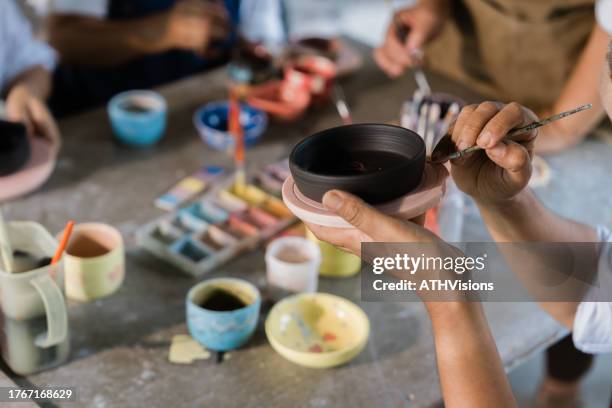 senior woman hands painting pottery ceramics at class - keramik bildbanksfoton och bilder