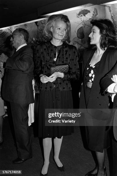 Guest, Chessy Rayner, and Anouk Aimee attend an event at the Cafe Carlysle in New York City on April 12, 1984.