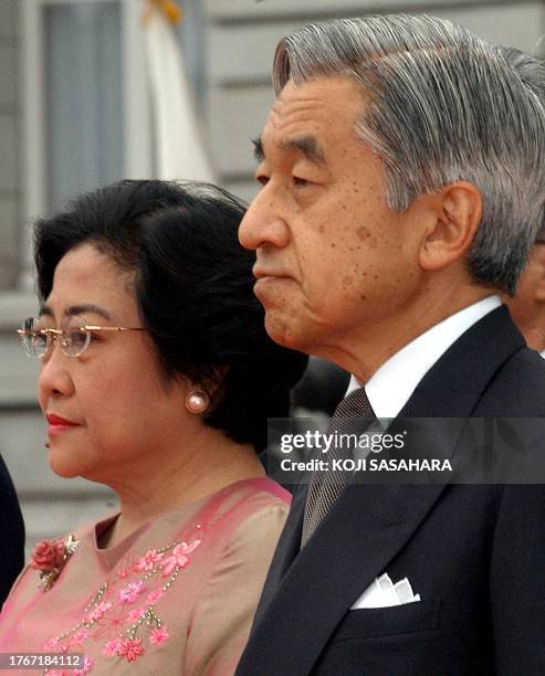 Indonesian President Megawati Sukarnoputri , and Japanese Emperor Akihito listen to national anthems during a welcoming ceremony at Akasaka Palace...