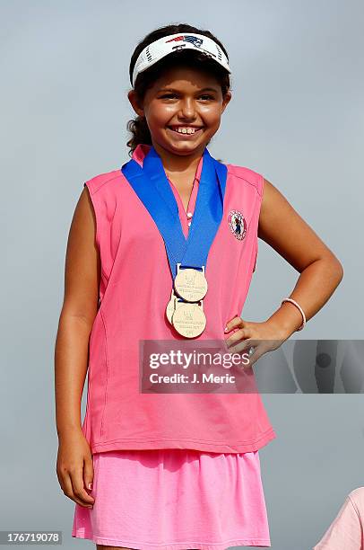 Regional Finals Girls 7-9 overall champion Alexa Pano smiles after receiving her medal at the Drive, Chip and Putt competition on August 17, 2013 in...