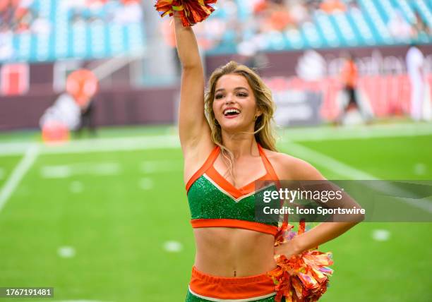 Miami cheerleader performs on the field before the start the college football game between the Virginia Cavaliers and the University of Miami...