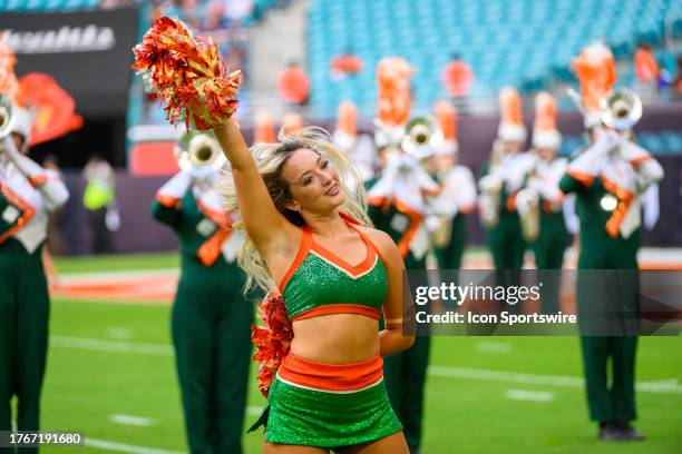 Miami cheerleader performs on the field before the start the college football game between the Virginia Cavaliers and the University of Miami...