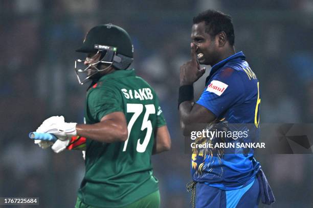 Sri Lanka's Angelo Mathews reacts beside Bangladesh's captain Shakib Al Hasan during the 2023 ICC Men's Cricket World Cup one-day international match...