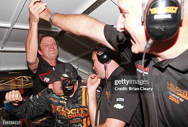 Wayne Taylor, L, celebrates with his crew after winning the SFP Grand Prix at Kansas Speedway on August 17, 2013 in Kansas City, Kansas.