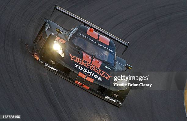 The Corvette DP of Jordan Taylor and Max Angelelli races through a turn during the SFP Grand Prix at Kansas Speedway on August 17, 2013 in Kansas...