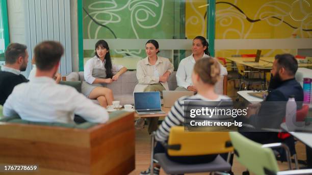 group of diverse multi-ethnic business people gathering together and enjoying talking with each other in modern co-working office space. - persian ethnicity stock pictures, royalty-free photos & images