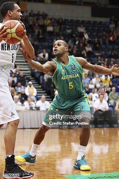 Patt Mills of the Boomers defends Everard Bartlett of the Tall Blacks during the Men's FIBA Oceania Championship match between the Australian Boomers...