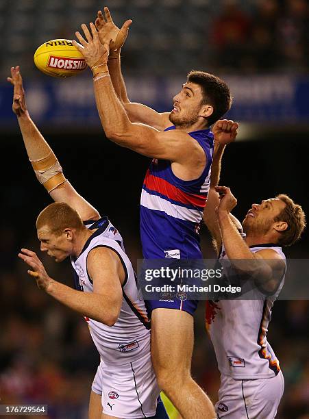 Tom Campbell of the Bulldogs marks the ball against Sam Jacobs and Ben Rutten of the Crows during the round 21 AFL match between the Western Bulldogs...