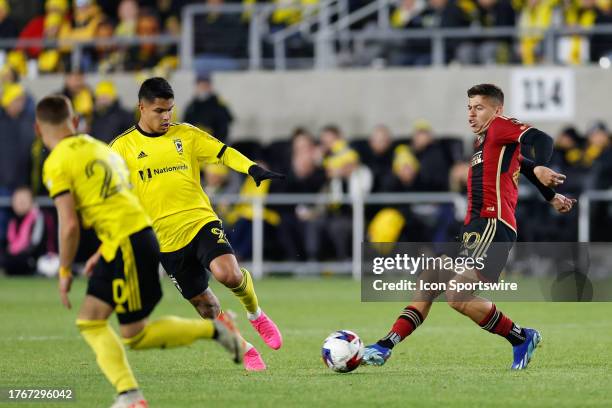 Atlanta United midfielder Matheus Rossetto passes the ball as Columbus Crew forward Cucho Hernandez comes in for the challenge during the second half...