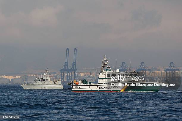 British Royal Navy vessel and a Spanish Guardia Civil boat patrol the water during a protest by Spanish fishermen in the sea near the Spain/Gibraltar...