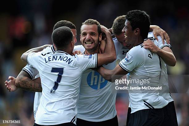Roberto Soldado of Tottenham Hotspur celebrates scoring from the penalty spot with team mates during the Barclays Premier League match between...