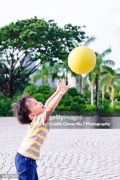 little boy throws dodgeball - boys sport pants stock pictures, royalty-free photos & images