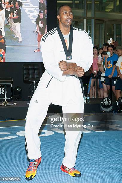 Player Dwight Howard of the Houston Rockets does the 'Gangnam Style' dance after the One Point Clinic Session at the Times Square in Seoul on August...