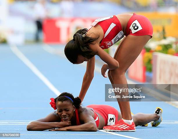 Ajee Wilson of the United States consoles Alysia Johnson Montano of the United States as she lies on the track after falling at the finish line in...