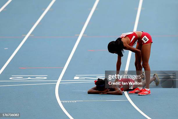 Ajee Wilson of the United States consoles Alysia Johnson Montano of the United States as she lies on the track after falling at the finish line in...