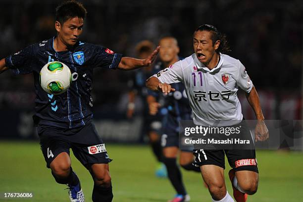 Kazuki Hara of Kyoto Sanga and Bae Seung Jin of Yokohama FC compete for the ball during the J.League second division match between Yokohama FC and...