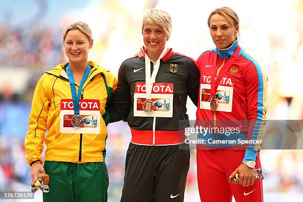 Silver medalist Kimberley Mickle of Australia, gold medalist Christina Obergfoll of Germany and bronze medalist Maria Abakumova of Russia stand on...